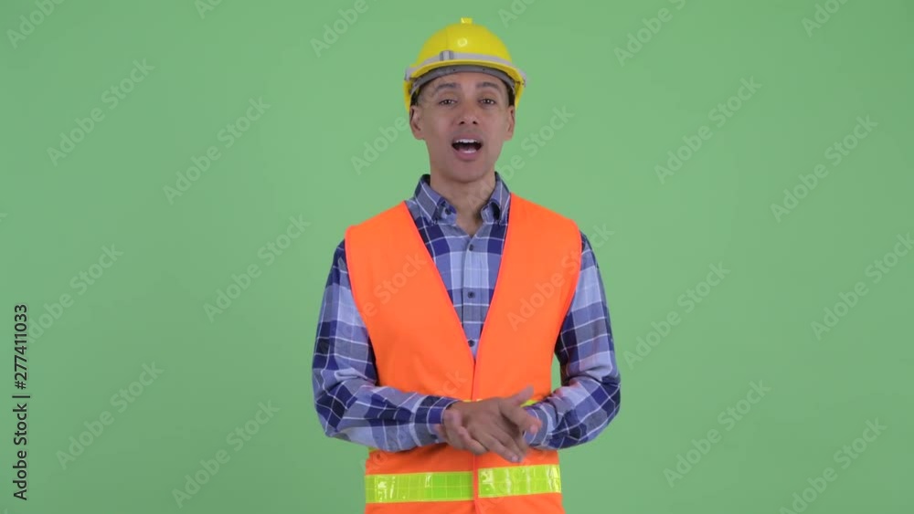 Happy multi ethnic man construction worker explaining something Happy multi ethnic man construction worker explaining something