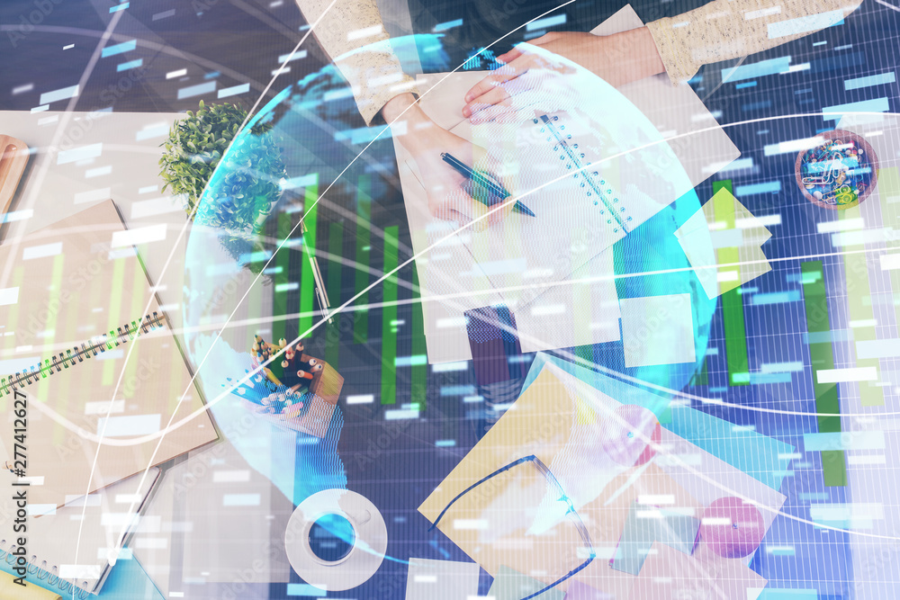 International business hologram over woman's hands taking notes background. Concept of success. Double exposure International business hologram over woman's hands taking notes background. Concept of success. Double exposure