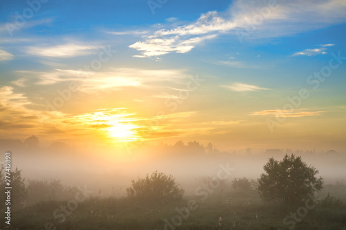 summer landscape with sunrise and fog © yanikap