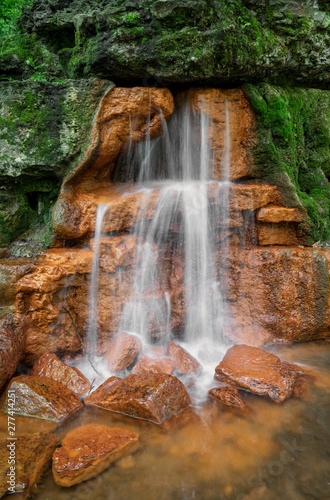 Water from The Yellow Spring - The Yellow Spring gushes water from an outcropping of rocks, stained orange yellow from high iron content, at Glen Helen Nature Preserve in Greene County, Ohio.