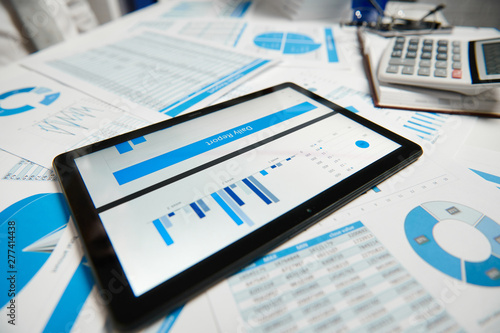 Office workspace for business. Tablet pc and reports. Table closeup. Business financial accounting concept.