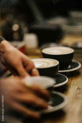 hands holding a cup of coffee