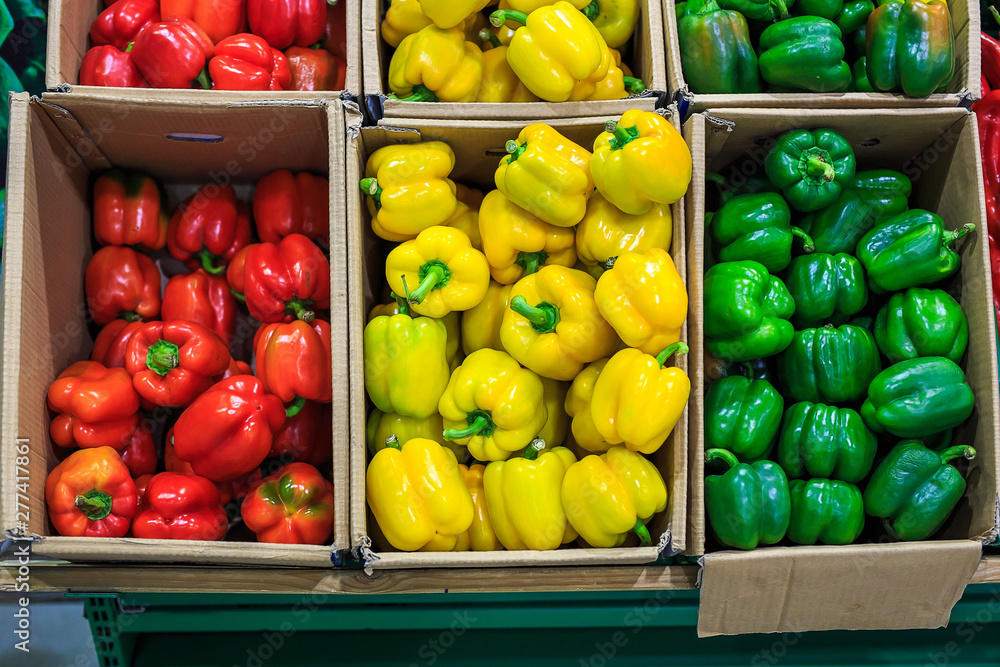 Cardboard boxes with yellow green and red bell peppers in markets Cardboard boxes with yellow green and red bell peppers in markets