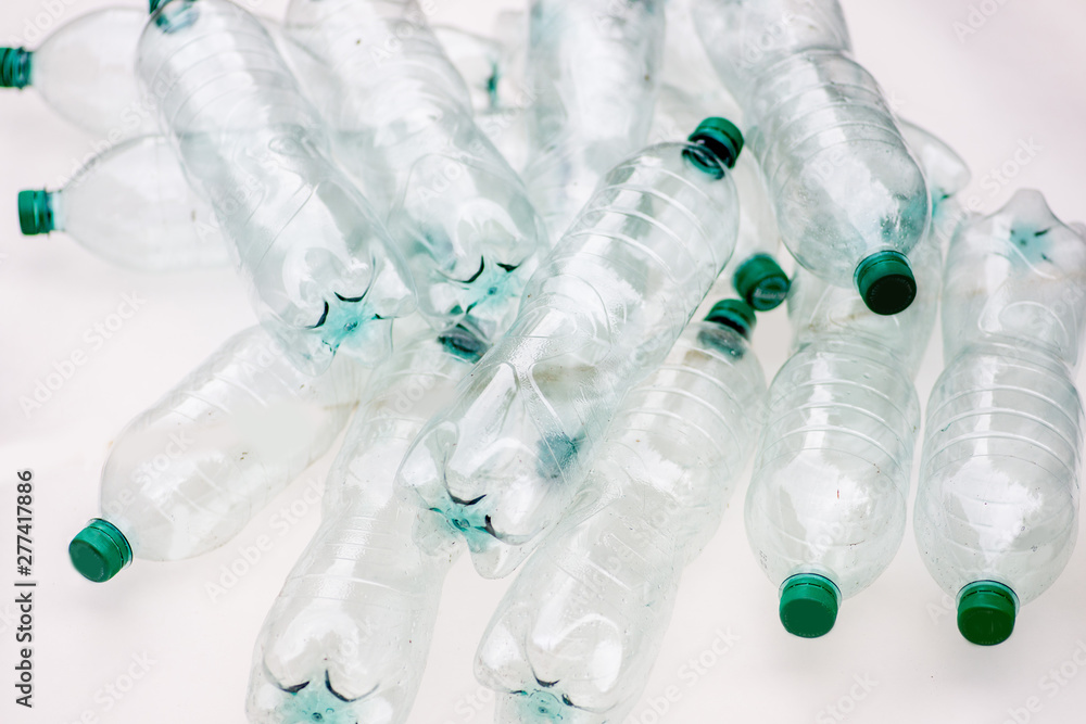 heap of empty crumpled plastic bottles on a white background heap of empty crumpled plastic bottles on a white background