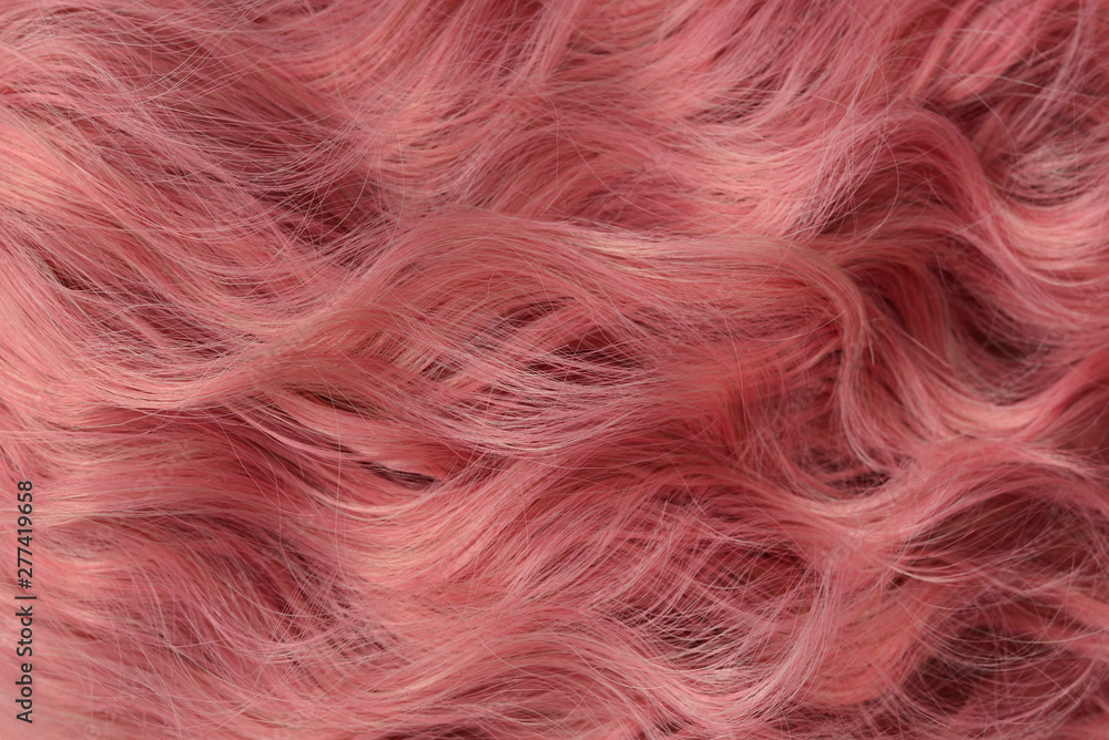 Fototapeta premium Pink wavy hair pattern. Top view.