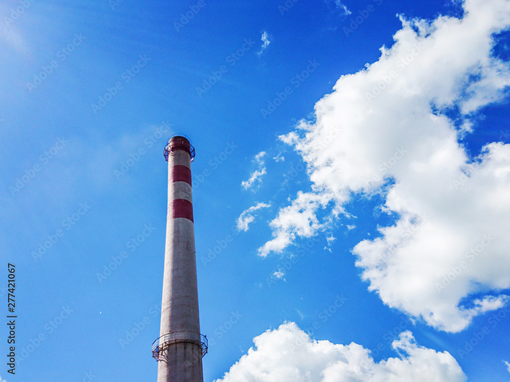 Brick factory pipe on a background of blue sky with white clouds. Bottom view. The concept of cleaner production. Mobile photo. Brick factory pipe on a background of blue sky with white clouds. Bottom view. The concept of cleaner production. Mobile photo.