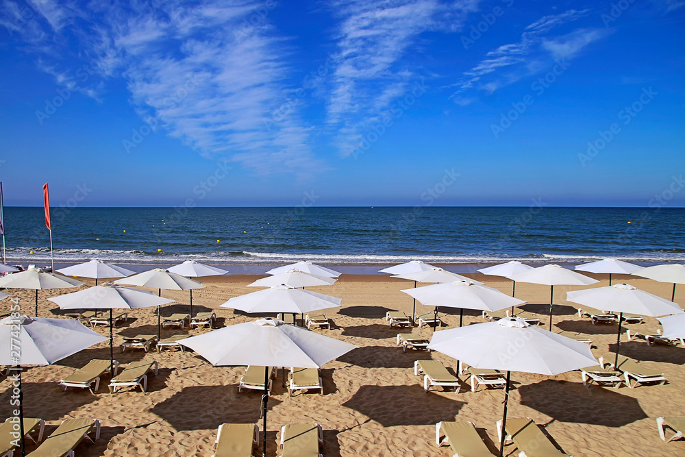 Sun loungers and parasols on Matalascañas beach, in the Doñana Natural Park, in Andalusia, southern Spain