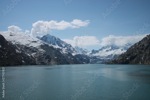 View of Glacier Bay National Park and Preserve from the water, with peaks on both sides. 