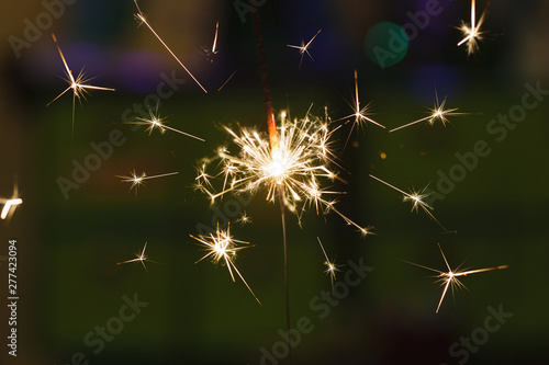 Sparks from hand cold fireworks color background