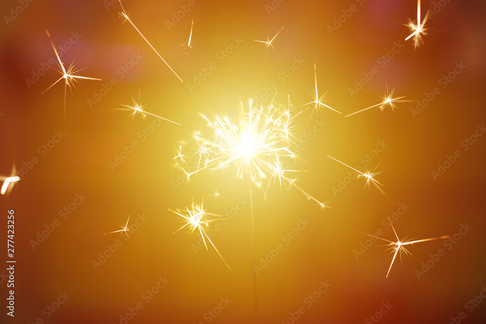 Sparks from hand cold fireworks color background