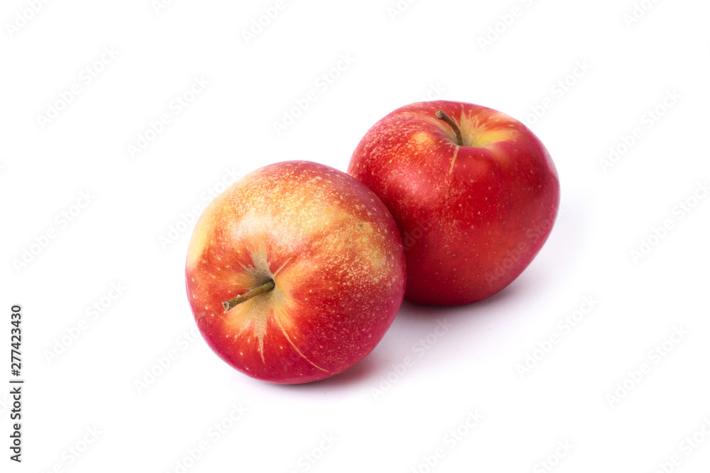Two red apples on a white background. Juicy apples of red color with yellow specks. Fruit is ripe and juicy on a white background. Two red apples on a white background. Juicy apples of red color with yellow specks. Fruit is ripe and juicy on a white background.