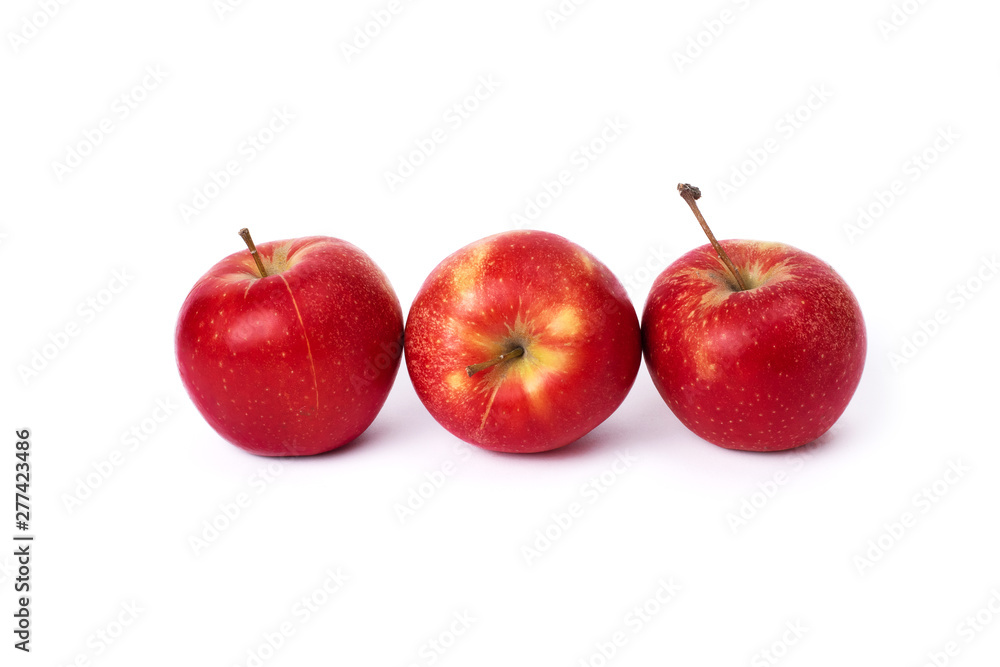 Three red apples on a white background. Juicy apples of red color with yellow specks on a white background. A group of ripe apples on an isolated background.