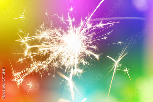 Sparks from hand cold fireworks colorful background