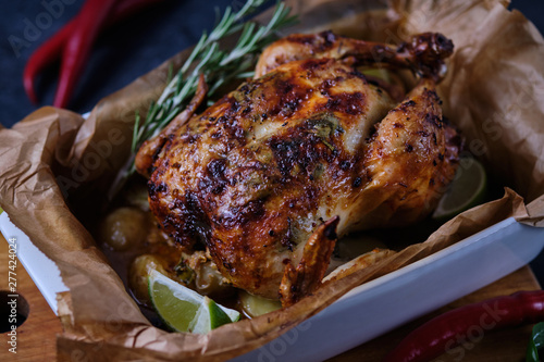 Chicken baked in the oven with spices, lemon, herbs and young potatoes.