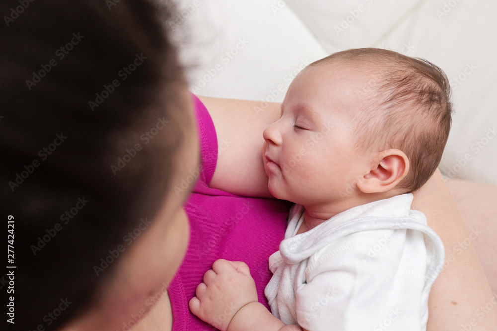 Mother Lovingly Holding her Newborn Baby Tight Mother Lovingly Holding her Newborn Baby Tight