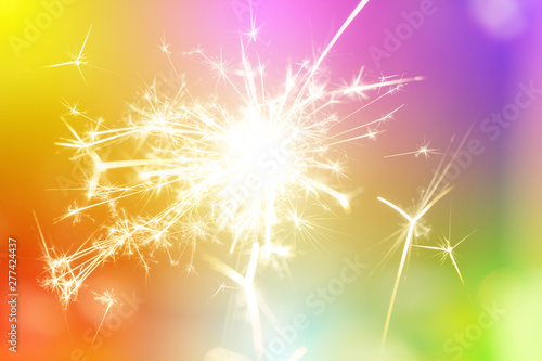 Sparks from hand cold fireworks bright sunspot colorful background