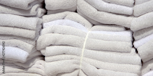 Close up cut-out view of a load of fresh white hotel towels ready for room service