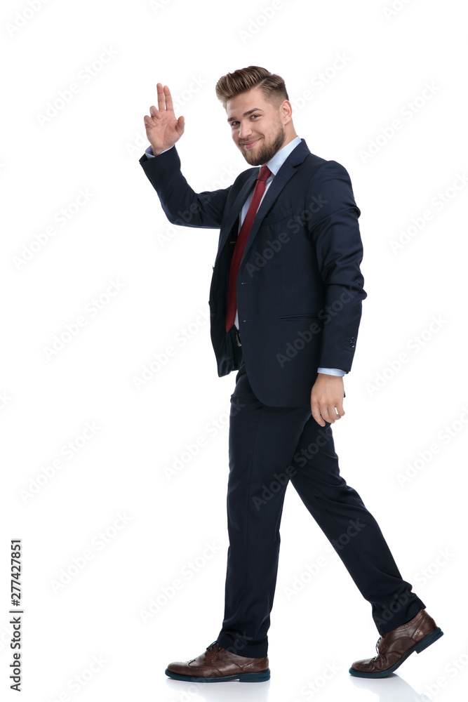 Side view of a businessman walking and greeting Side view of a businessman walking and greeting