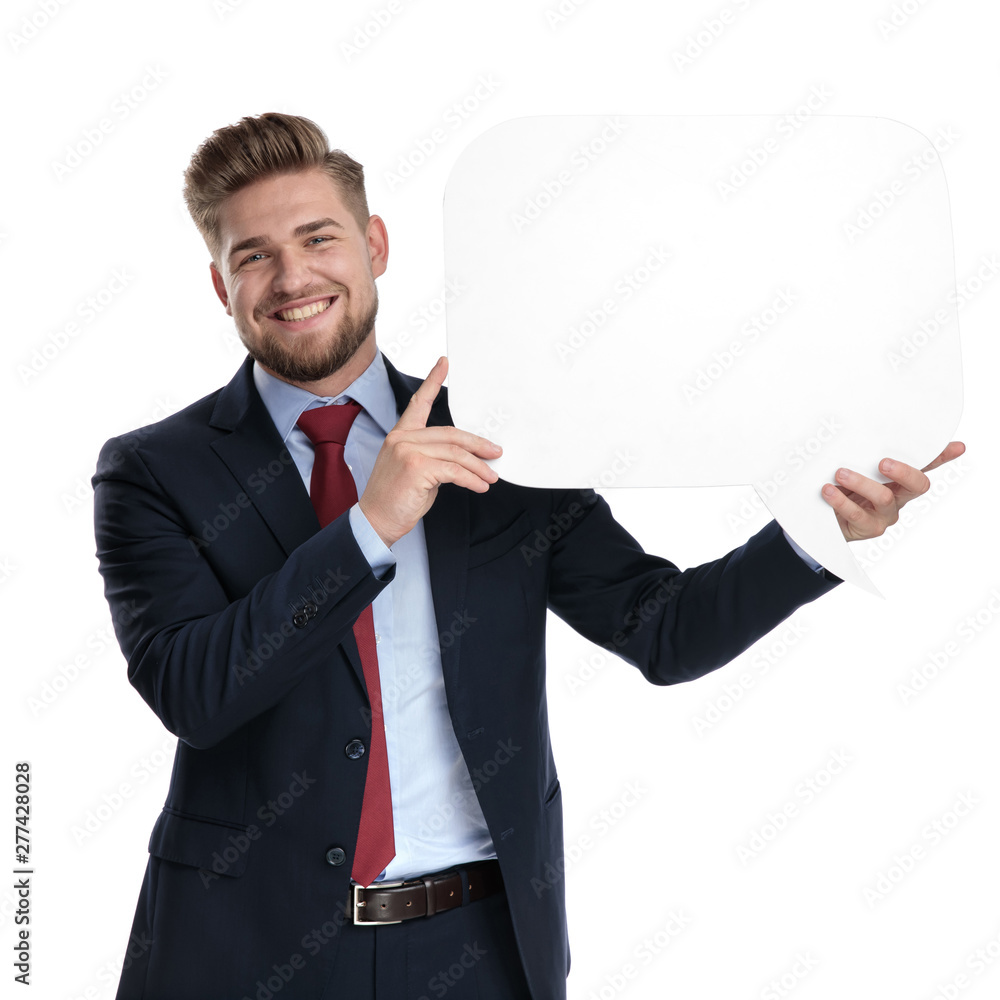 Positive businessman holding a blank speech bubble and laughing Positive businessman holding a blank speech bubble and laughing