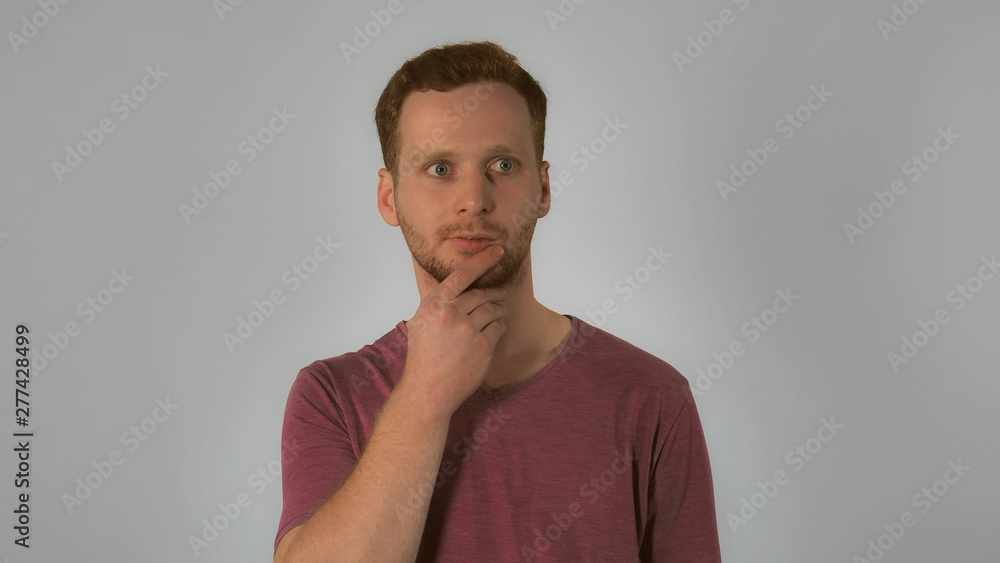 portrait happy young caucasian man on grey background. caucasian guy with red hair posing showing hand gesture have idea. handsome redhead men wearing in casual t-shirt portrait happy young caucasian man on grey background. caucasian guy with red hair posing showing hand gesture have idea. handsome redhead men wearing in casual t-shirt