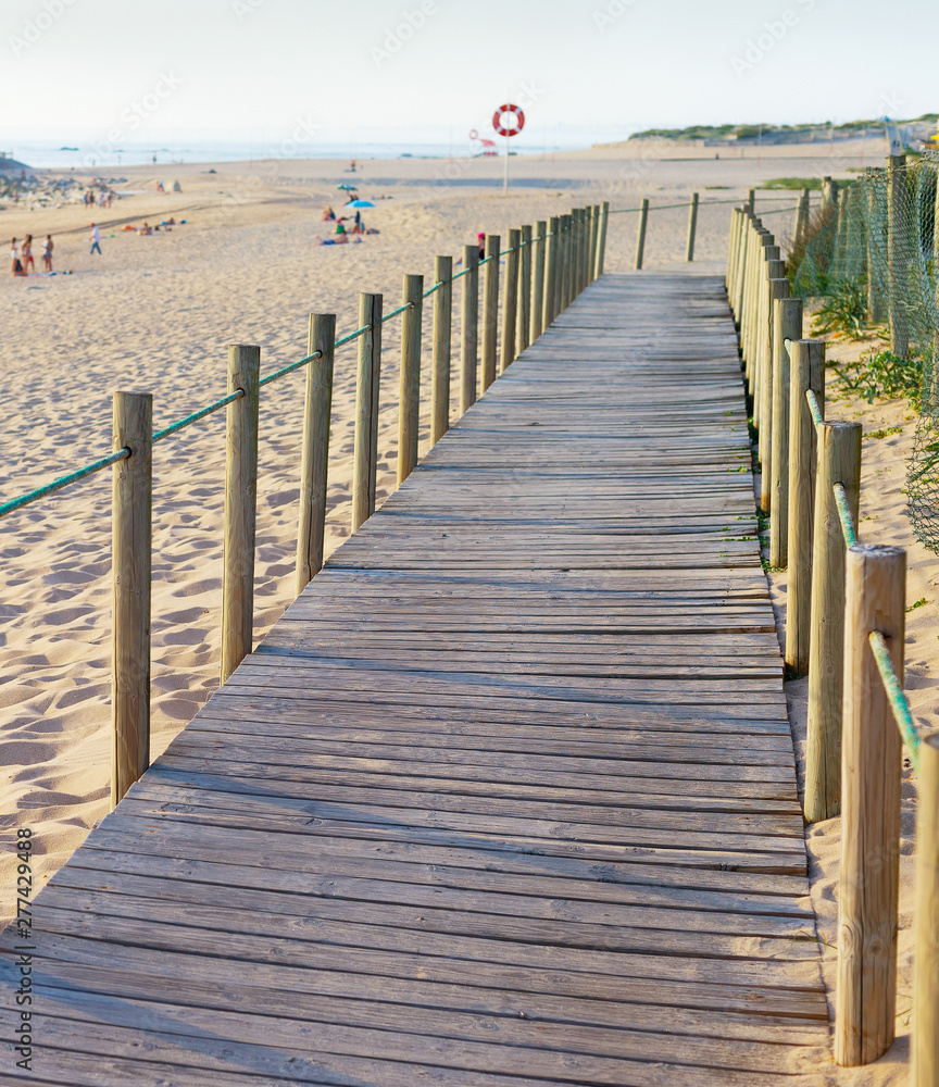 Fototapeta premium Wooden walkway, people, beach, church
