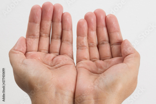 Close-up of a woman's hand and finger on white background