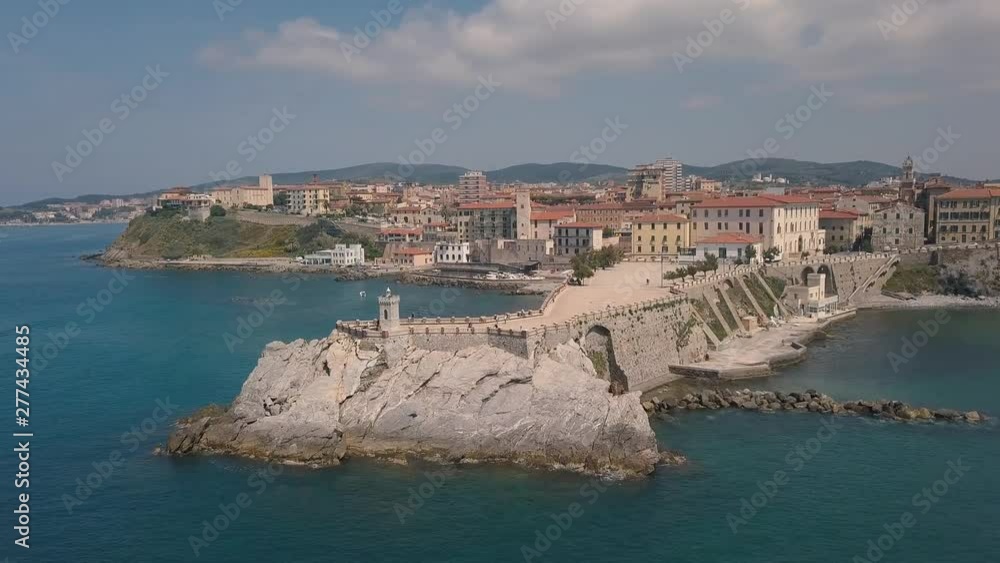 Aerial view of the coast of Piombino. Flight over the sea and pier. Maremma Tuscany Italy. Aerial view of the coast of Piombino. Flight over the sea and pier. Maremma Tuscany Italy.