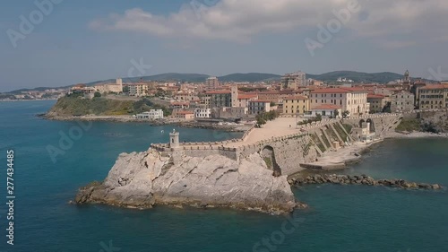 Aerial view of the coast of Piombino. Flight over the sea and pier. Maremma Tuscany Italy.