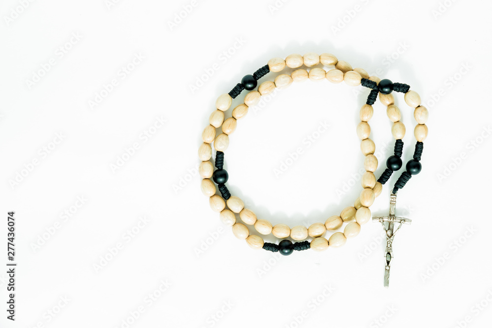 Rosary on a white, isolated background. The concept of Christian faith, Catholicism. Pray for grace, faith in God. Problems of the Catholic church, priests' blemishes. Rosary on a white, isolated background. The concept of Christian faith, Catholicism. Pray for grace, faith in God. Problems of the Catholic church, priests' blemishes.
