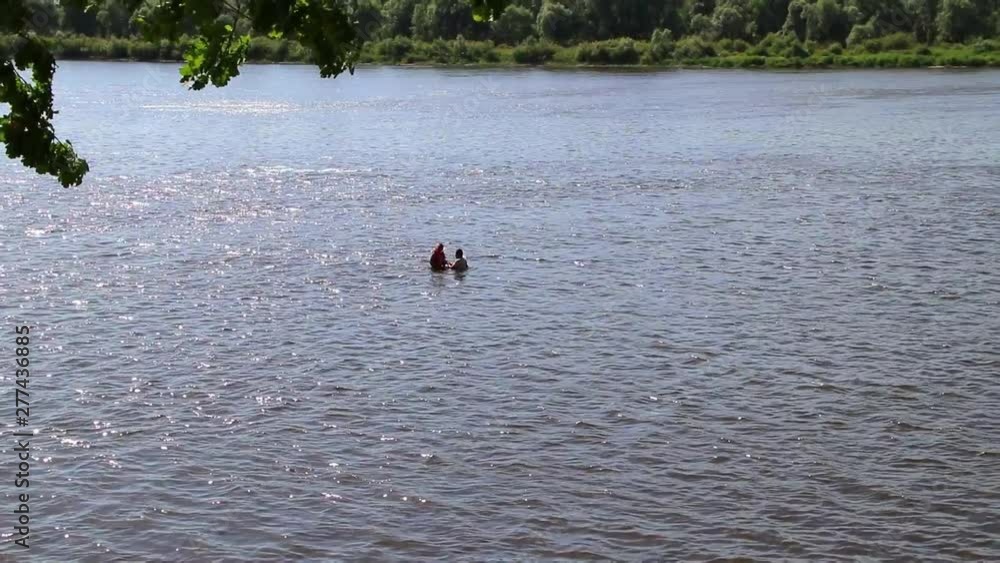 A person leads a healthy lifestyle and swims in the river to increase the strength of his body and spirit, extreme relaxation fitness and relaxation in nature to relieve stress and be healthy A person leads a healthy lifestyle and swims in the river to increase the strength of his body and spirit, extreme relaxation fitness and relaxation in nature to relieve stress and be healthy