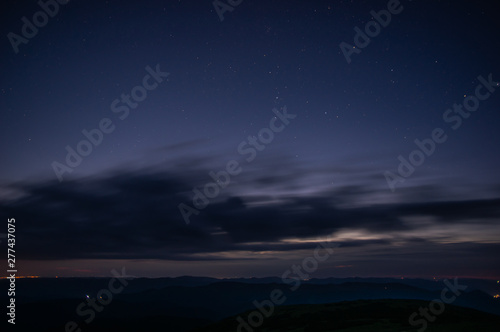 Stars in the predawn sky above the mountains