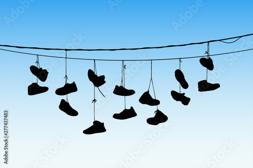 Shoes on wires. Vector illustration with silhouette of old shoes hanging on power lines. Blue pastel background