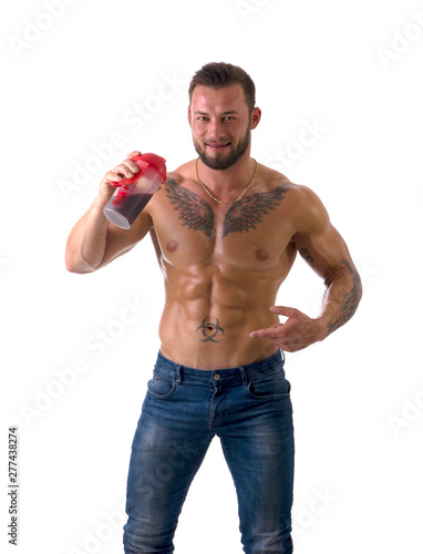 Muscular shirtless male bodybuilder drinking protein shake from blender. Isolated on white