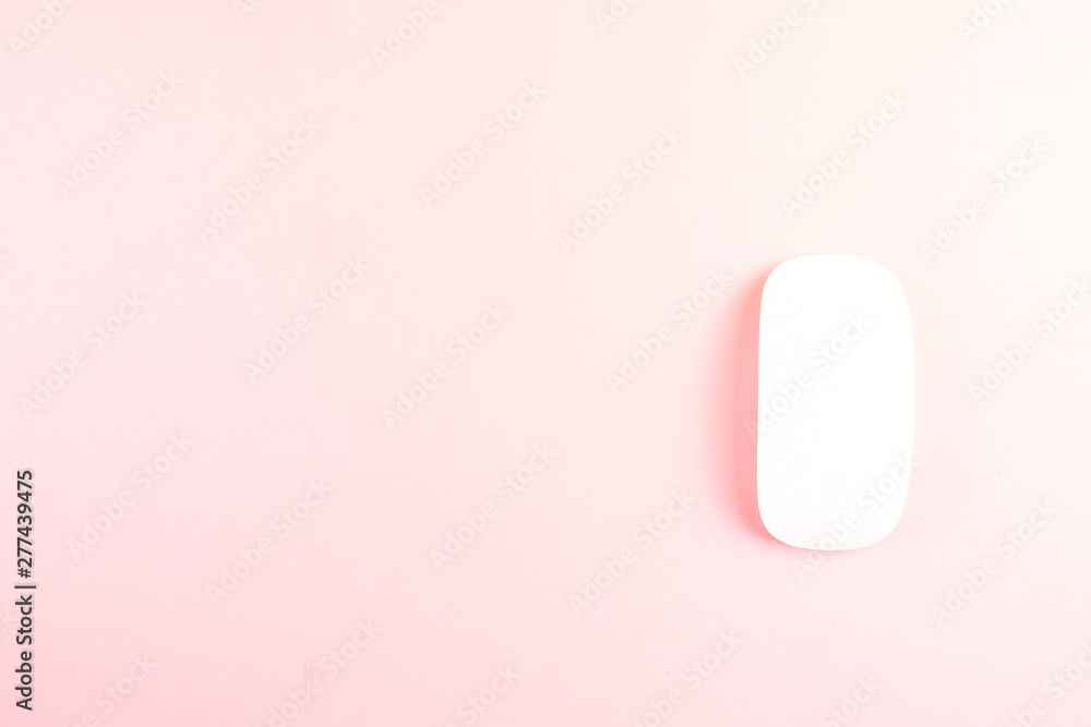 White laptop mouse over pink background. White laptop mouse over pink background.