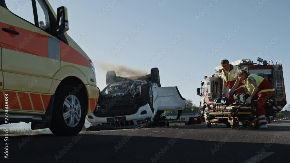 Rescue Team of Firefighters and Paramedics Work on a Terrible Car Crash ...