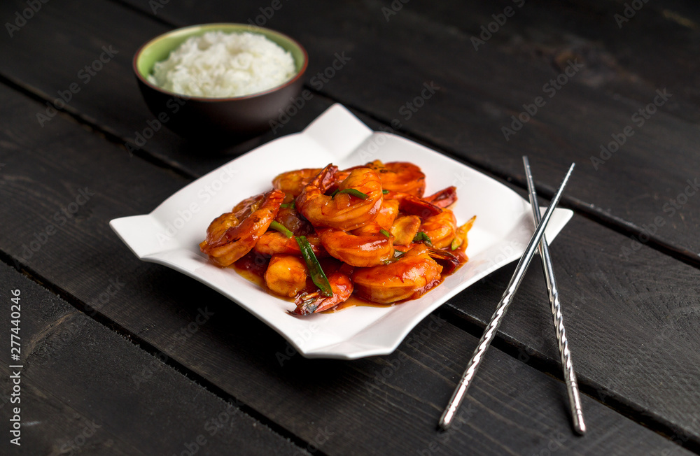 Fotografie Ketchup shrimp plate on dark background