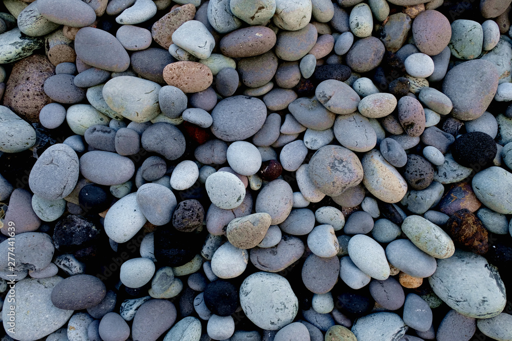 A collection of gray round stones, various sizes and shapes, various minerals, close view. A collection of gray round stones, various sizes and shapes, various minerals, close view.