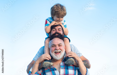 Happy man family have fun together. Fathers day - grandfather, father and son are hugging and having fun together.