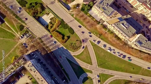 Top aerial view of traffic on elliptical road rotating