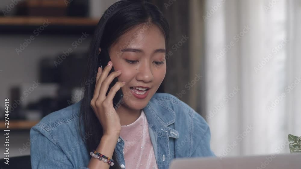 Beautiful portrait asian woman creative design talking on the phone in home office. Girl smiling working freelance at home. Beautiful portrait asian woman creative design talking on the phone in home office. Girl smiling working freelance at home.