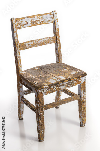 Old wooden chair with texture of flaking cracked paint peeling off isolated on a white background. Lead contamination concept