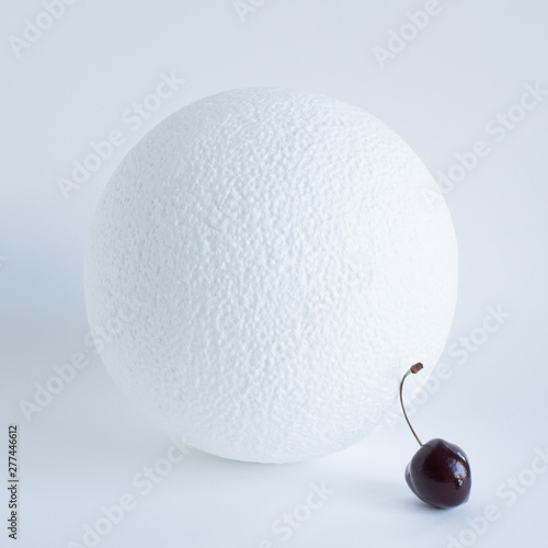 White foam ball and Burgundy cherry berry closeup on white background
