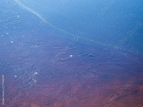 ice crust on the water of the spring lake photo