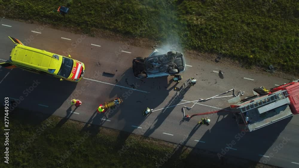 Aerial View: Rescue Team of Firefighters and Paramedics Work on a Car ...