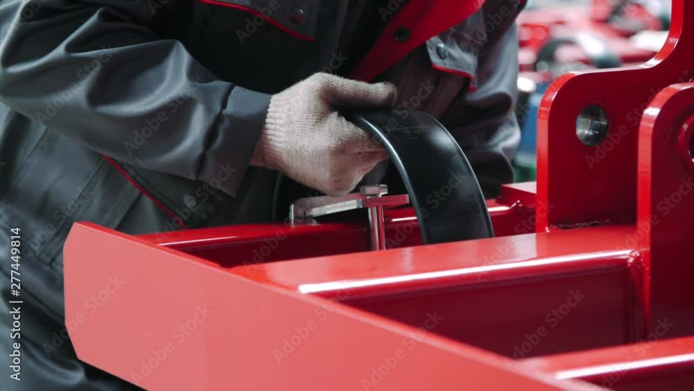 Worker making manual assembly on agricultural machinery production line