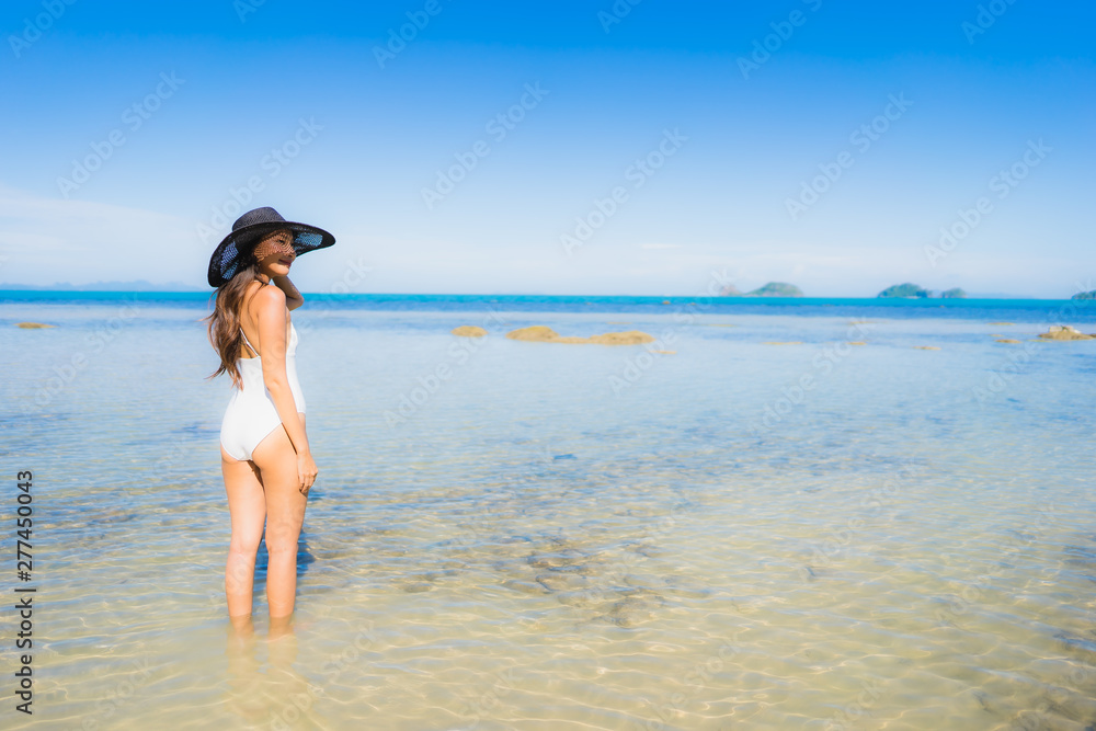 Portrait beautiful young asian woman looking sea beach ocean for relax in holiday vacation travel