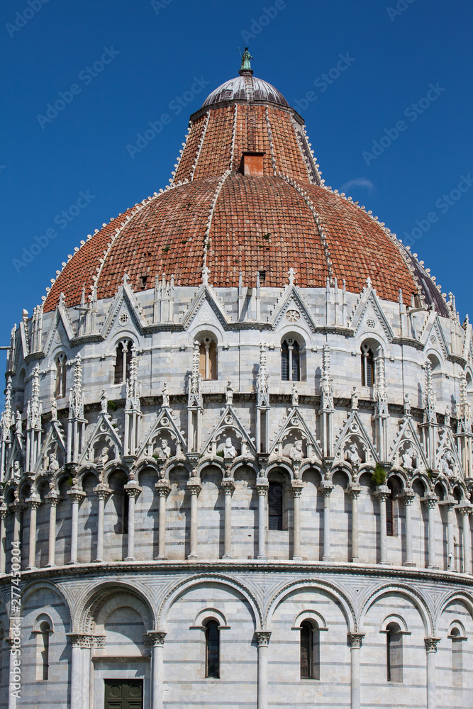 Detail of the cupola of the Pisa Baptistery of St. John against a beautiful blue sky