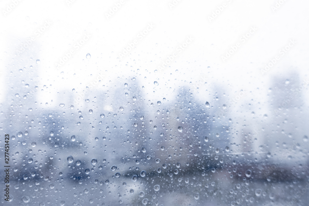 Abstract blurred of water dropped onto window in rainy season in Bangkok. Abstract blurred of water dropped onto window in rainy season in Bangkok.