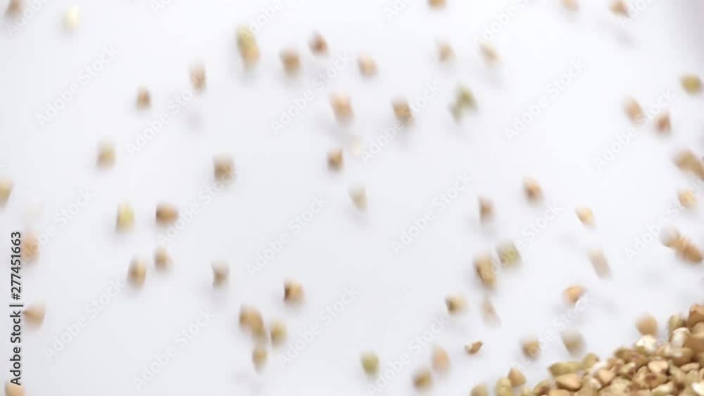 raw buckwheat on white background falling from top and filling up frame. slow motion 96fps raw buckwheat on white background falling from top and filling up frame. slow motion 96fps