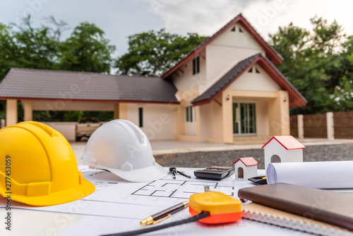 Architect desk with blueprint and hard hat constuction building. photo